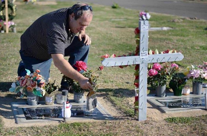 Darin Roam spends nearly all his time at his wife’s grave