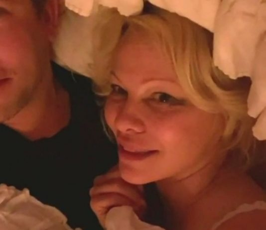 Pamela Anderson Shocks TV Hosts During Chaotic Interview in Bed With Hubby (Video)
